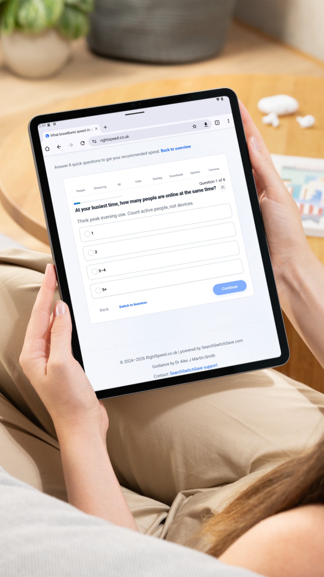 A person using RightSpeed.co.uk on a tablet to answer the question 'At your busiest time, how many people are online at the same time?'