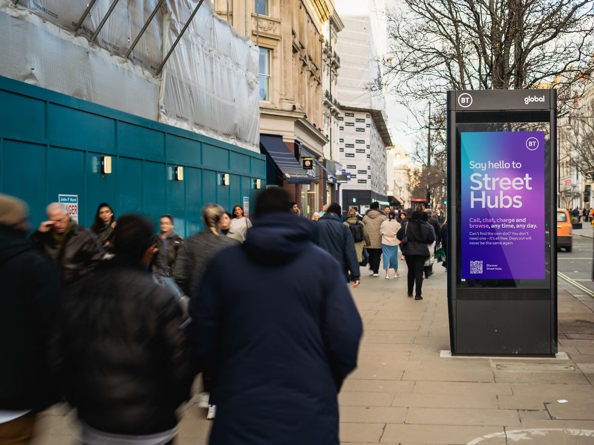 BT Street Hub digital unit on a busy shopping street with a large screen reading Say hello to Street Hubs