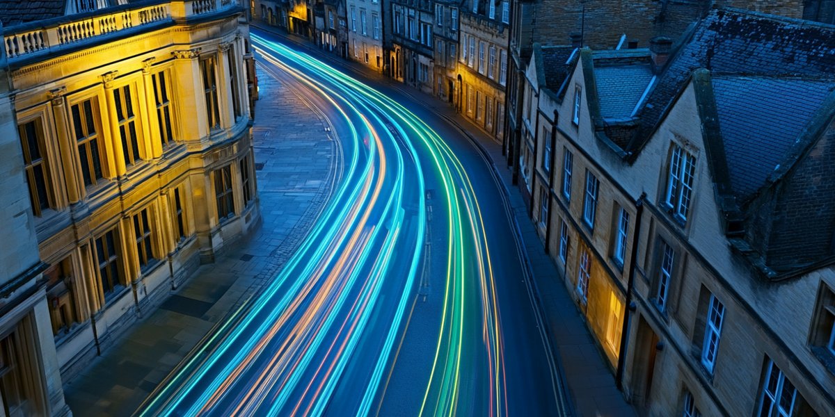 City skyline at dusk with light trails sweeping through the streets