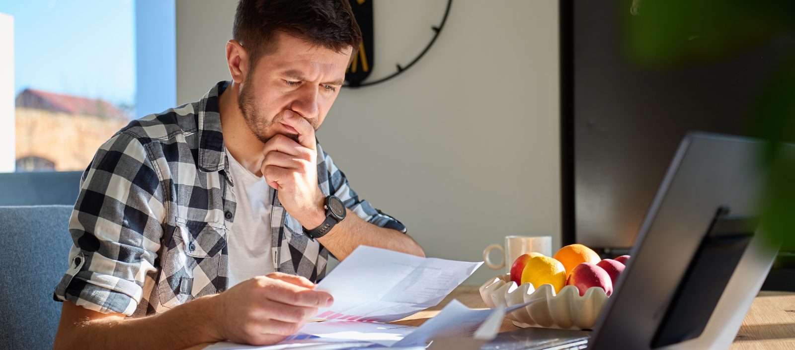 Customer reviewing broadband contract paperwork and complaint deadlines at home
