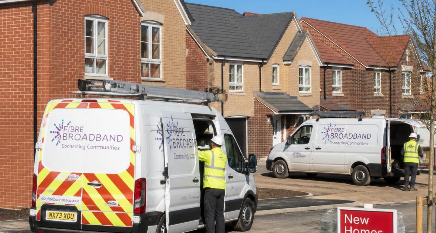 Fibre broadband installation vans outside new build homes in the UK